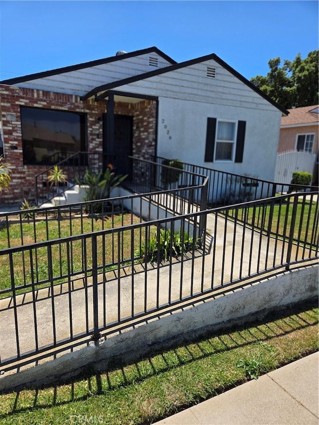 2026 W 94th Pl, Los Angeles, CA 90047 - single story home with a fenced front yard and brick siding