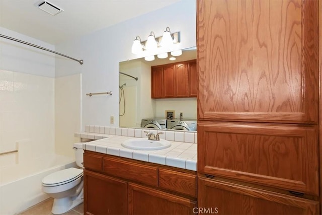 19126 Frances St, Apple Valley, CA 92308 - bathroom with washing machine and clothes dryer, tub / shower combination, toilet, and vanity