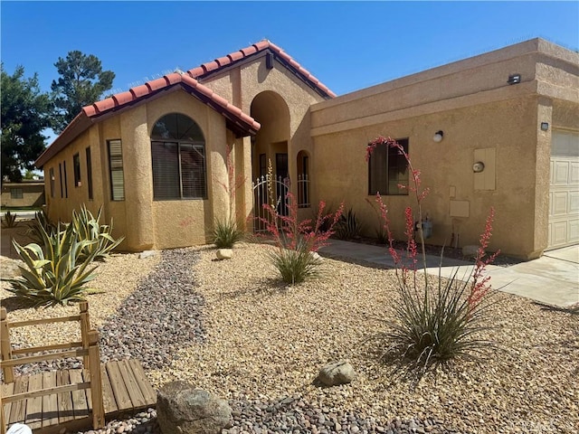 19126 Frances St, Apple Valley, CA 92308 - mediterranean / spanish house featuring a garage, stucco siding, a tiled roof, and concrete driveway