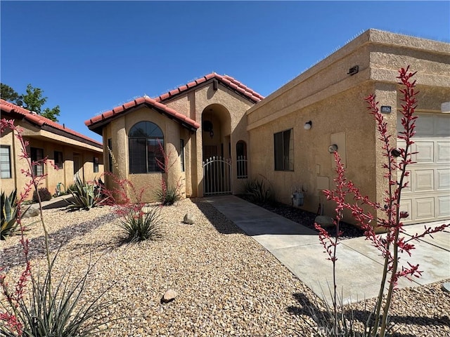 19126 Frances St, Apple Valley, CA 92308 - mediterranean / spanish-style house featuring stucco siding, a tiled roof, a garage, and a gate