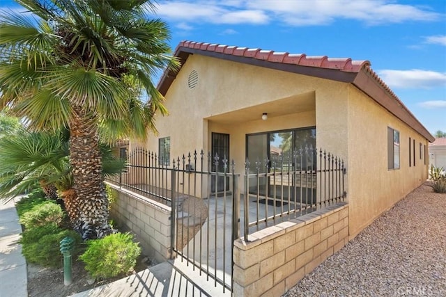 19126 Frances St, Apple Valley, CA 92308 - view of property exterior featuring stucco siding and a gate