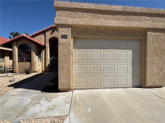 19126 Frances St, Apple Valley, CA 92308 - view of front of property with stucco siding, concrete driveway, a tile roof, and a garage