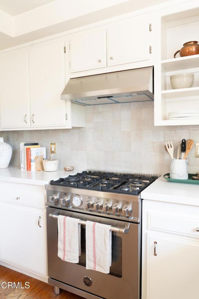 202 N Fulton St, Ojai, CA 93023 - kitchen featuring stainless steel stove, under cabinet range hood, light countertops, white cabinetry, and tasteful backsplash