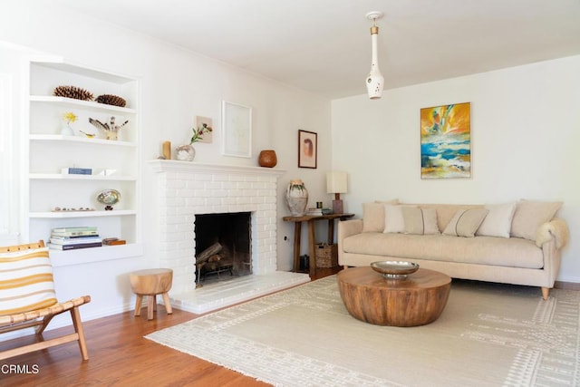 202 N Fulton St, Ojai, CA 93023 - living room featuring wood finished floors, a brick fireplace, and built in features