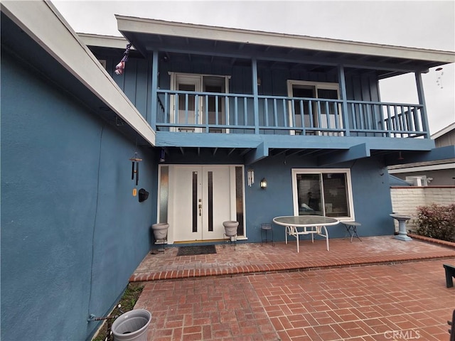 17352 Rob Roy Cir, Huntington Beach, CA 92647 - back of property with a balcony, french doors, stucco siding, and a patio area