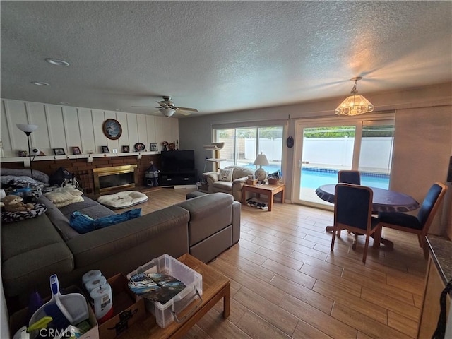 17352 Rob Roy Cir, Huntington Beach, CA 92647 - living area featuring a textured ceiling, ceiling fan, a chandelier, and wood finished floors