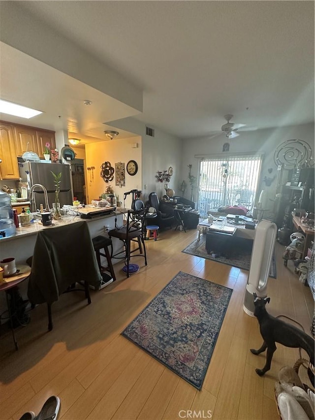 17888 Alburtis Ave Unit B112, Artesia, CA 90701 - living area featuring ceiling fan and light wood-style flooring