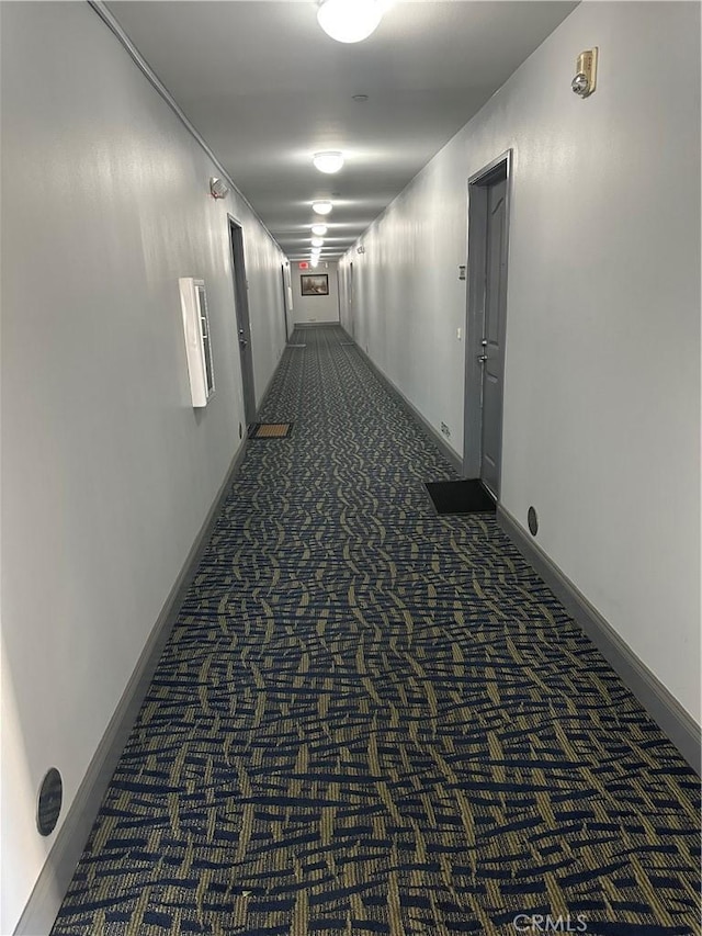 17888 Alburtis Ave Unit B112, Artesia, CA 90701 - hall featuring dark carpet and baseboards