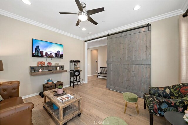 44260 Nighthawk Pass, Temecula, CA 92592 - living room with a ceiling fan, a barn door, crown molding, wood finished floors, and recessed lighting