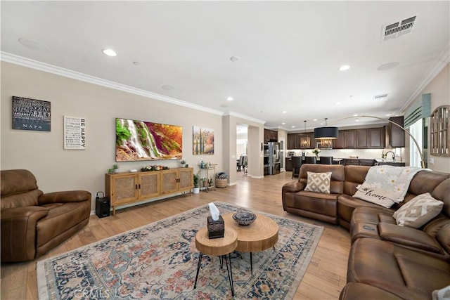 44260 Nighthawk Pass, Temecula, CA 92592 - living room featuring crown molding, light wood-type flooring, and recessed lighting