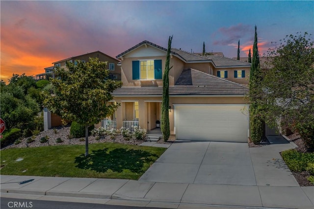 44260 Nighthawk Pass, Temecula, CA 92592 - traditional-style house featuring an attached garage, covered porch, a tiled roof, driveway, and a front lawn