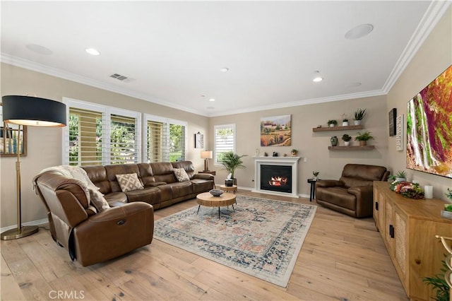 44260 Nighthawk Pass, Temecula, CA 92592 - living room featuring a lit fireplace, ornamental molding, light wood-style flooring, baseboards, and recessed lighting