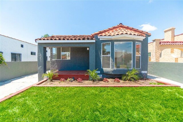 6751 7th Ave, Los Angeles, CA 90043 - mediterranean / spanish house featuring a tiled roof, stucco siding, and a porch