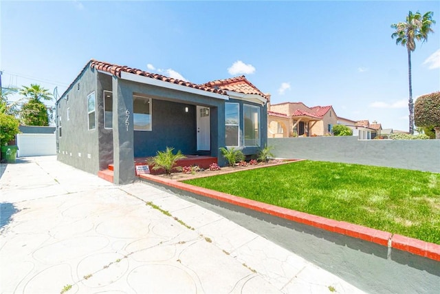 6751 7th Ave, Los Angeles, CA 90043 - mediterranean / spanish-style home featuring stucco siding, a tiled roof, an outdoor structure, and driveway