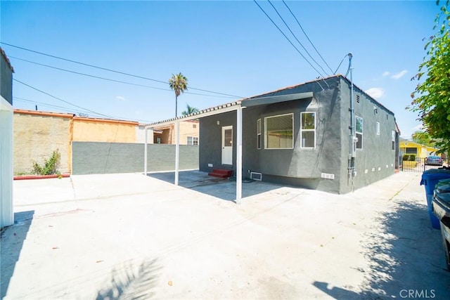 6751 7th Ave, Los Angeles, CA 90043 - rear view of house with stucco siding and entry steps