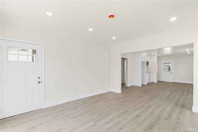 6751 7th Ave, Los Angeles, CA 90043 - unfurnished living room with light wood-style floors, recessed lighting, and baseboards