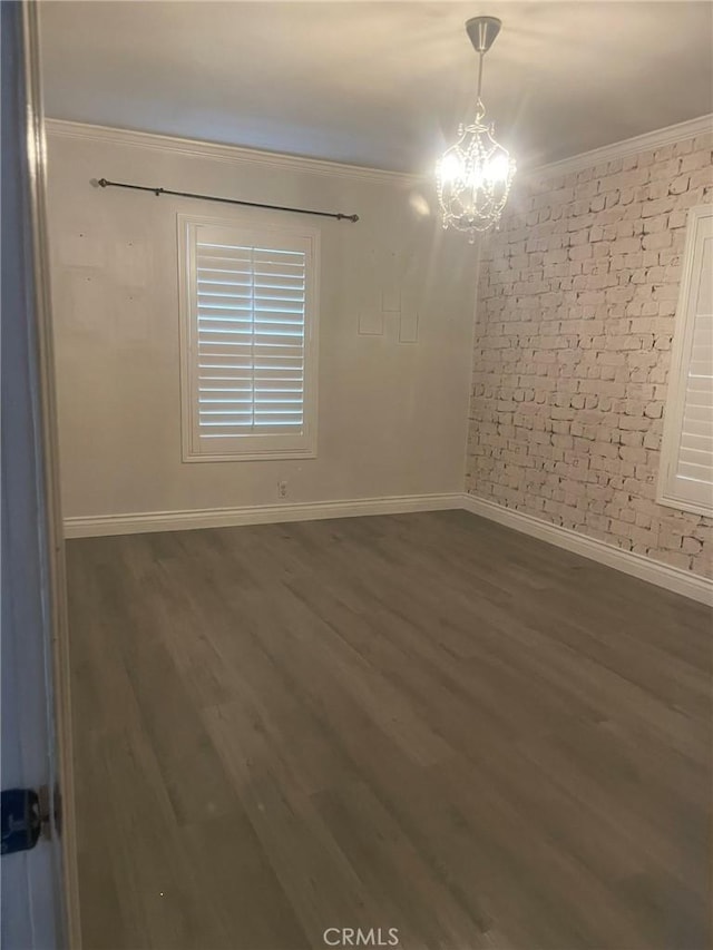 11022 Maple St, Whittier, CA 90601 - empty room with ornamental molding, a chandelier, wood finished floors, and brick wall