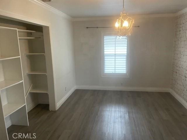 11022 Maple St, Whittier, CA 90601 - unfurnished dining area with a chandelier, wood finished floors, baseboards, and crown molding