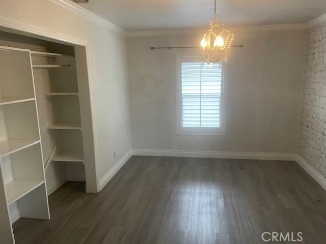 11022 Maple St, Whittier, CA 90601 - unfurnished dining area featuring a chandelier, wood finished floors, and crown molding