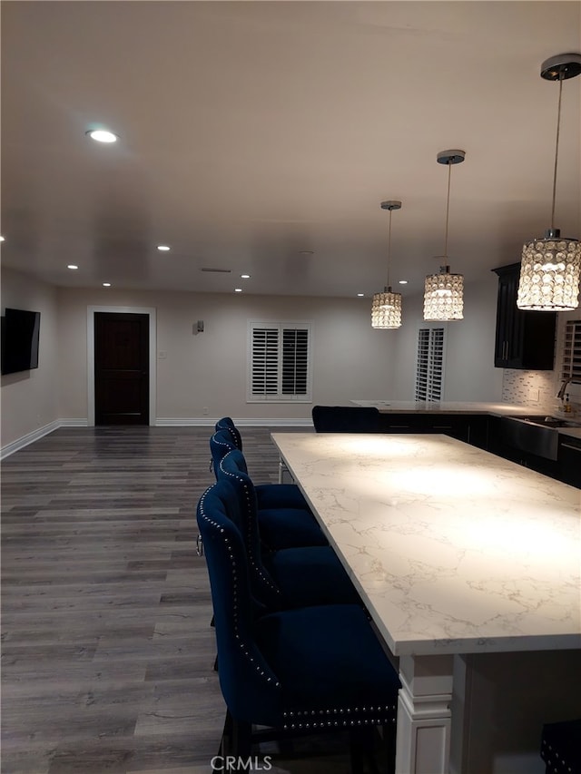 11022 Maple St, Whittier, CA 90601 - kitchen with dark wood finished floors, open floor plan, recessed lighting, decorative light fixtures, and a breakfast bar