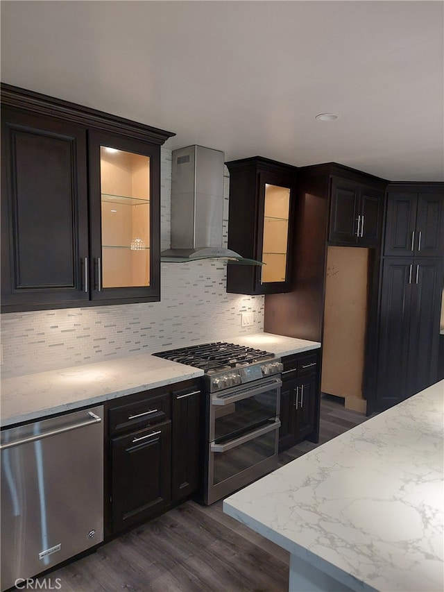11022 Maple St, Whittier, CA 90601 - kitchen with stainless steel appliances, wall chimney exhaust hood, dark wood-type flooring, and backsplash