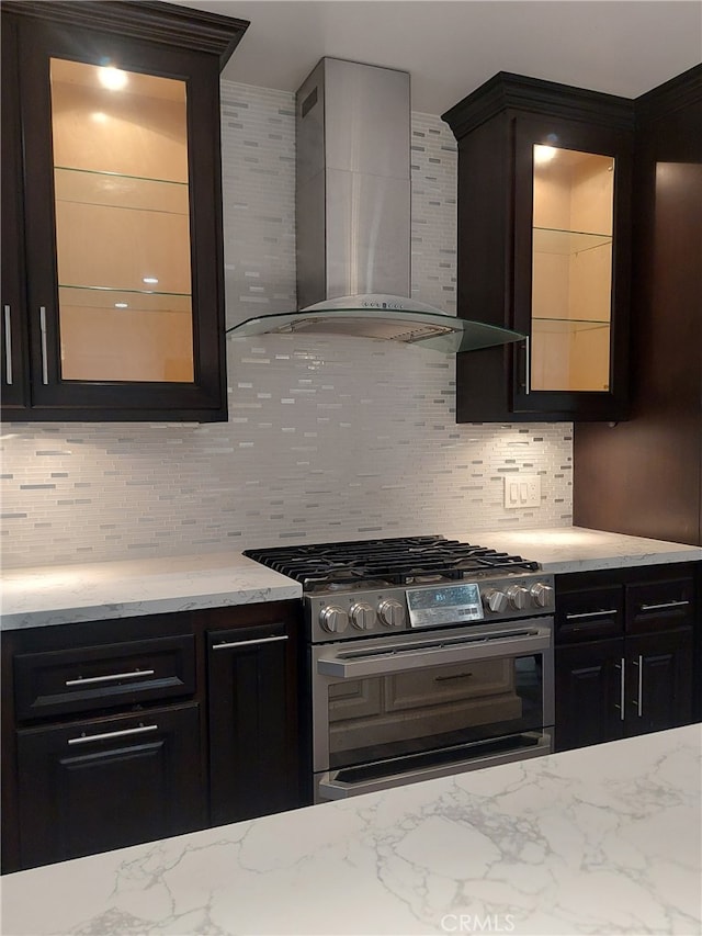 11022 Maple St, Whittier, CA 90601 - kitchen with stainless steel range with gas cooktop, wall chimney range hood, backsplash, and glass insert cabinets