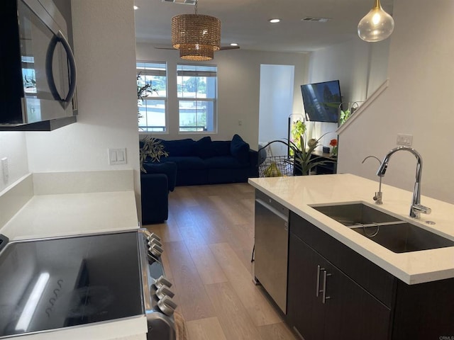 7641 University Ave Unit 105, La Mesa, CA 91942 - kitchen featuring appliances with stainless steel finishes, a sink, dark cabinets, light countertops, and recessed lighting