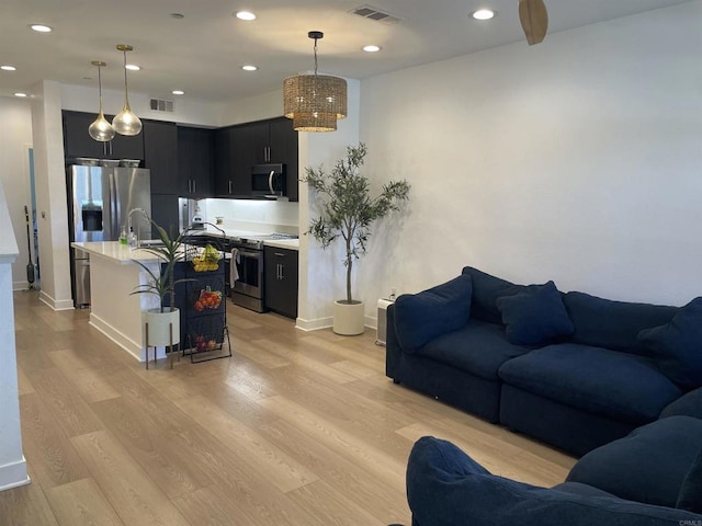 7641 University Ave Unit 105, La Mesa, CA 91942 - living room featuring light wood-style floors, baseboards, and recessed lighting