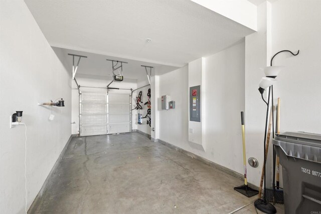 7641 University Ave Unit 105, La Mesa, CA 91942 - garage featuring baseboards, electric panel, and a garage door opener