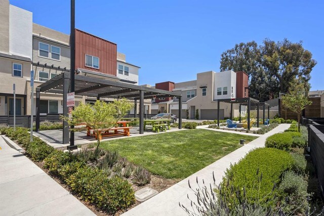 7641 University Ave Unit 105, La Mesa, CA 91942 - view of property's community with a pergola, a residential view, and a lawn