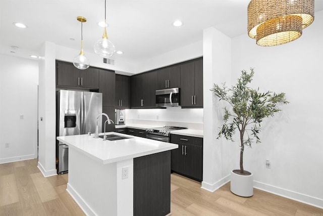 7641 University Ave Unit 105, La Mesa, CA 91942 - kitchen featuring stainless steel appliances, a sink, light wood-style floors, light countertops, and recessed lighting