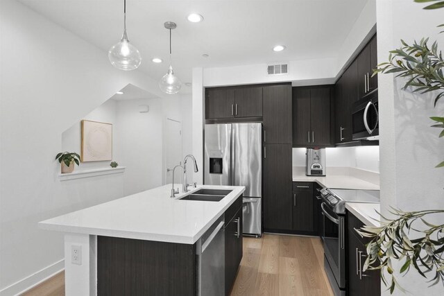 7641 University Ave Unit 105, La Mesa, CA 91942 - kitchen with stainless steel appliances, a sink, light countertops, light wood finished floors, and recessed lighting