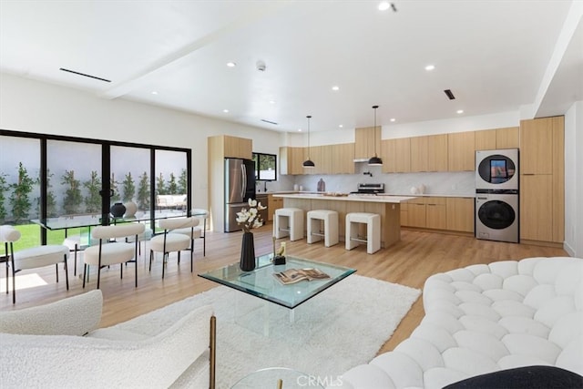 22452 Dolorosa St, Woodland Hills, CA 91367 - living area with stacked washer / drying machine, light wood-style flooring, and recessed lighting