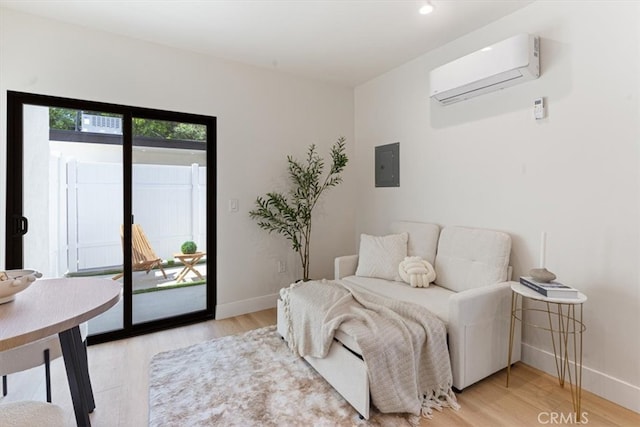 22452 Dolorosa St, Woodland Hills, CA 91367 - sitting room featuring a wall mounted AC, baseboards, light wood-type flooring, and electric panel
