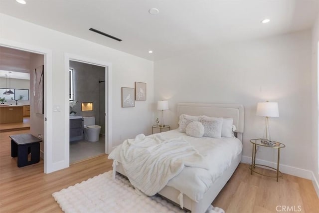 22452 Dolorosa St, Woodland Hills, CA 91367 - bedroom with wood finished floors, baseboards, recessed lighting, a sink, and connected bathroom