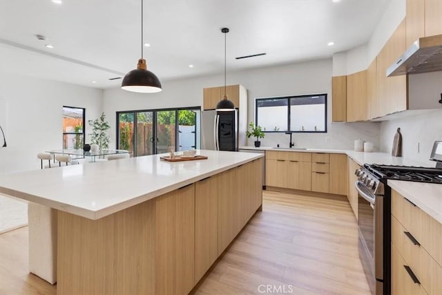 22452 Dolorosa St, Woodland Hills, CA 91367 - kitchen with stainless steel appliances, light brown cabinetry, modern cabinets, light wood-style flooring, and recessed lighting