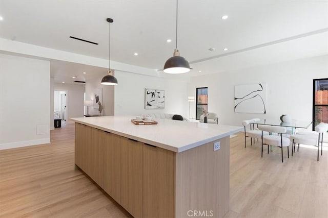 22452 Dolorosa St, Woodland Hills, CA 91367 - kitchen with modern cabinets, light wood-type flooring, a spacious island, open floor plan, and pendant lighting