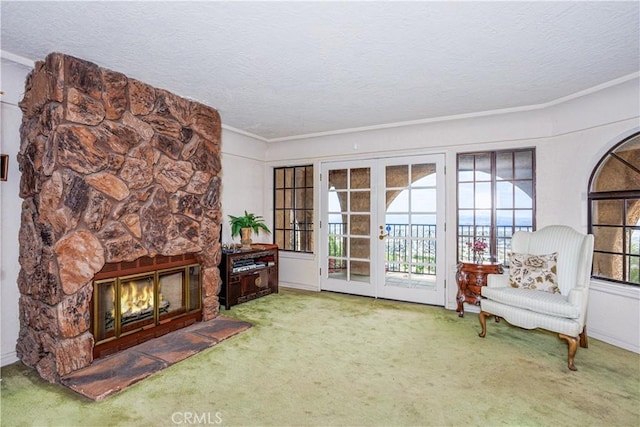 350 Roughrider Rd, La Verne, CA 91750 - sitting room featuring carpet, a stone fireplace, a textured ceiling, crown molding, and french doors