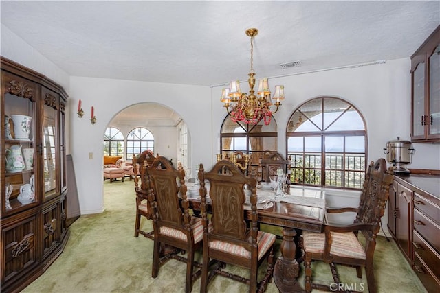 350 Roughrider Rd, La Verne, CA 91750 - dining room featuring light colored carpet, a chandelier, arched walkways, and baseboards