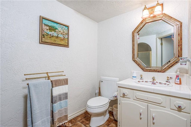 350 Roughrider Rd, La Verne, CA 91750 - bathroom with a textured wall, vanity, toilet, a textured ceiling, and tile patterned flooring