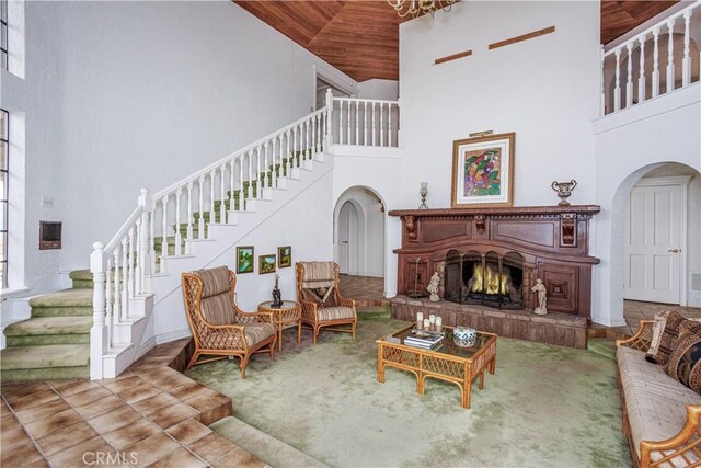 350 Roughrider Rd, La Verne, CA 91750 - living room with a towering ceiling, stairway, arched walkways, wood ceiling, and a lit fireplace