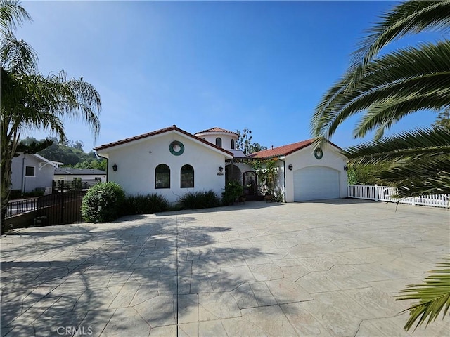 9740 La Canada Way, Shadow Hills, CA 91040 - mediterranean / spanish-style home with stucco siding, a garage, a tiled roof, and concrete driveway