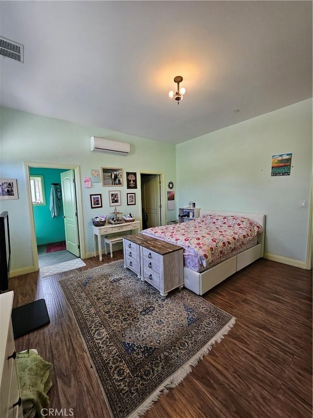 9740 La Canada Way, Shadow Hills, CA 91040 - bedroom with a wall unit AC, dark wood-style floors, and baseboards