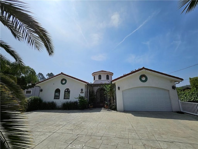 9740 La Canada Way, Shadow Hills, CA 91040 - mediterranean / spanish-style home featuring stucco siding, driveway, and an attached garage