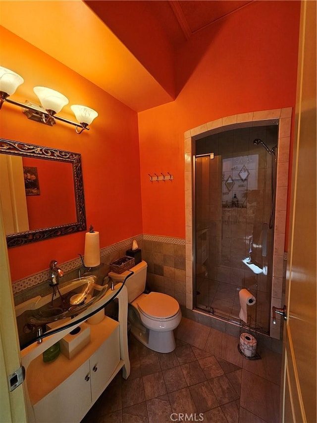 9740 La Canada Way, Shadow Hills, CA 91040 - bathroom featuring toilet, a stall shower, vanity, tile patterned floors, and tile walls