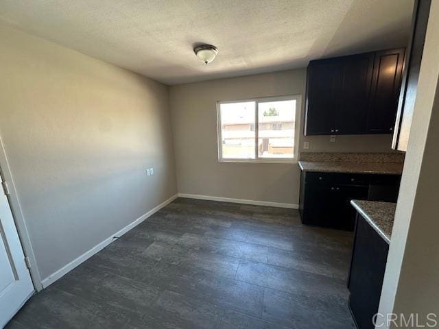 9731 Winter Gardens Blvd Unit 54, Lakeside, CA 92040 - kitchen with baseboards, dark cabinetry, and dark wood finished floors