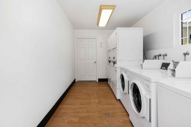 1025 4th Ave Unit 8, Chula Vista, CA 91911 - shared laundry with stacked washer / dryer, washing machine and clothes dryer, light wood-style floors, and baseboards