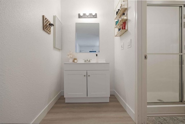 1025 4th Ave Unit 8, Chula Vista, CA 91911 - full bath with wood finished floors, a shower stall, a textured wall, vanity, and baseboards