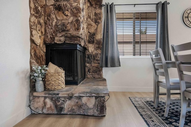 1025 4th Ave Unit 8, Chula Vista, CA 91911 - living room featuring wood finished floors, baseboards, and a stone fireplace