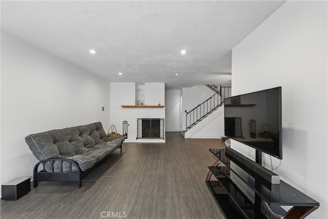 8121 Canby Ave Unit 4, Reseda, CA 91335 - living room featuring wood finished floors, stairs, a fireplace with raised hearth, and recessed lighting